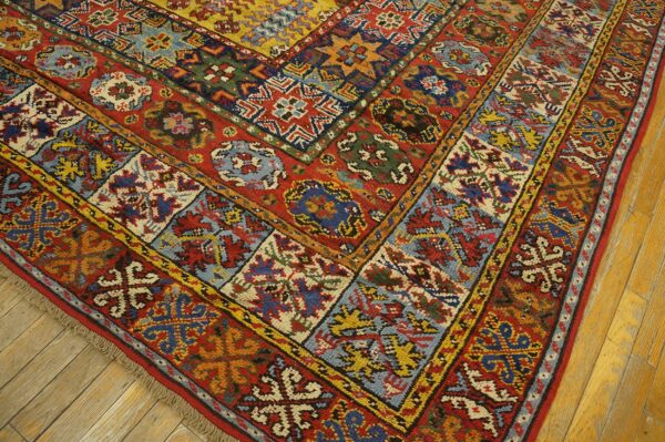 Close-up of a colorful, geometric rug corner on hardwood floors by rugs on net