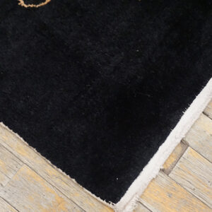 Intricate black and beige patterned rug