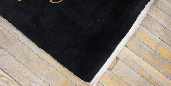 Intricate black and beige patterned rug