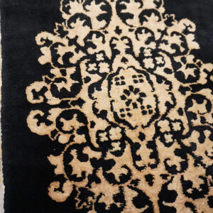 Black rug with golden intricate design