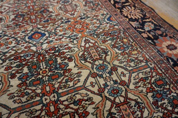 Close-up of the intricate floral pattern on the light-colored field of the persian rug by rugs on net. By rugs on net