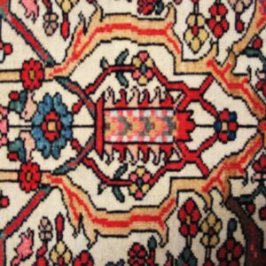Close-up of intricate floral medallion detail on a light-colored rug by Rugs On Net