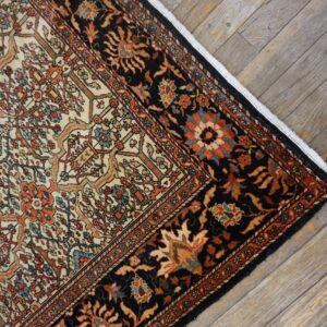 Corner detail of a traditional Persian rug with intricate floral patterns on a dark border, by Rugs On Net. by Rugs On Net