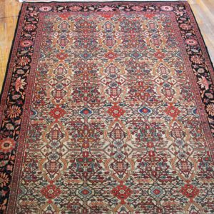 Close-up of a traditional Oriental rug with intricate red, blue, and cream patterns on a dark border, by Rugs On Net