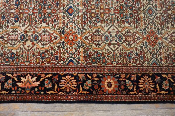 Close-up of the intricate floral patterns and dark border on the persian rug by rugs on net. By rugs on net