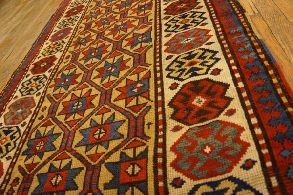 Close-up of a geometric runner rug with red, blue, and gold patterns on a wooden floor by rugs on net. By rugs on net