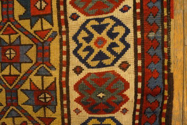 Close-up of geometric patterns on a vintage rug by rugs on net