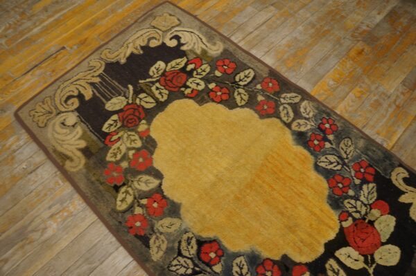 Close-up of a floral rug with red roses and a yellow center on a dark background by rugs on net