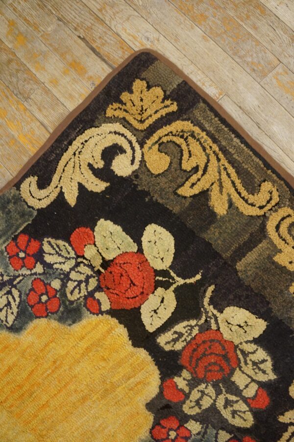 Close-up corner view of a vibrant floral and scrollwork rug on distressed wood flooring by rugs on net