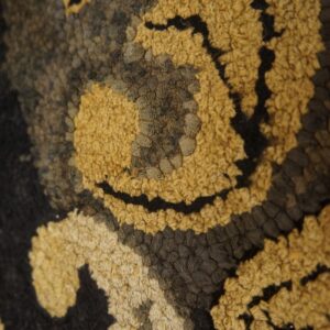 Close-up texture of a gold and black patterned rug by Rugs On Net
