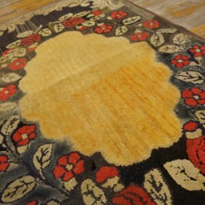 Close-up of a floral rug with a central yellow area and red flowers on a dark border by Rugs On Net
