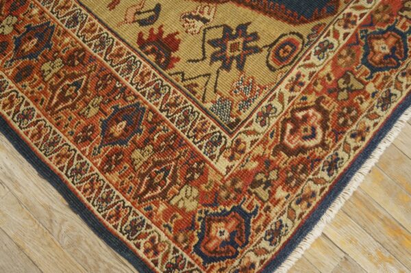 Close-up of the corner of a richly patterned rug featuring red, blue, and tan hues, by rugs on net. By rugs on net