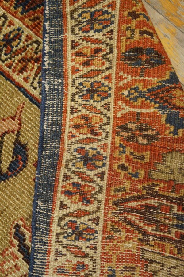 Close-up texture of the antique rug border featuring geometric patterns in red, blue, and beige tones by rugs on net. By rugs on net