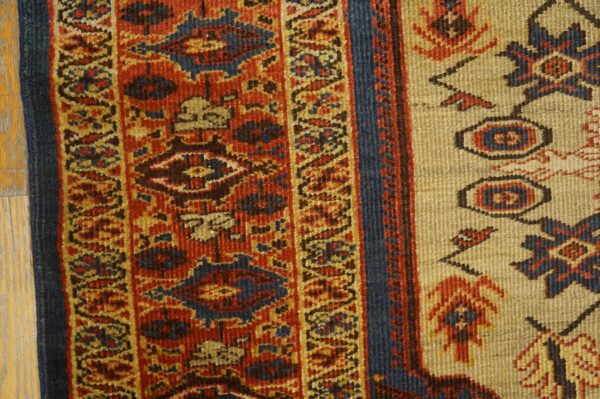 Close-up detail of a traditional rug border featuring red, blue, and gold geometric patterns by rugs on net. By rugs on net