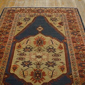A traditional rug with a dark blue mihrab design on a tan field, surrounded by red borders, by Rugs On Net. by Rugs On Net