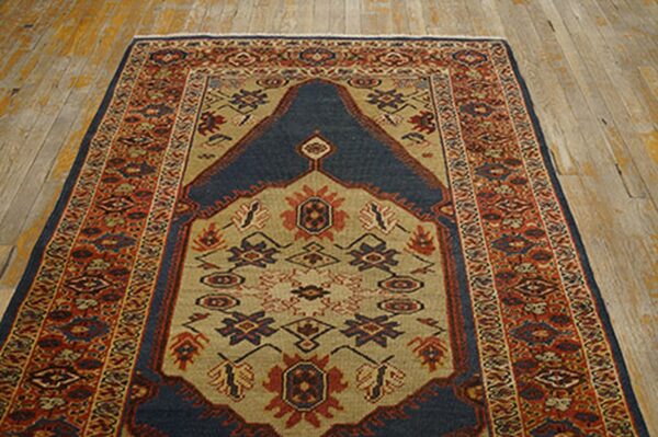 A traditional rug with a dark blue mihrab design on a tan field, surrounded by red borders, by rugs on net. By rugs on net
