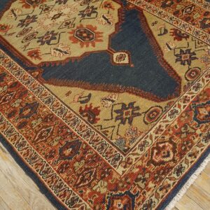 Close-up corner of a traditional rug featuring geometric patterns in rust, navy, and tan, by Rugs On Net. by Rugs On Net