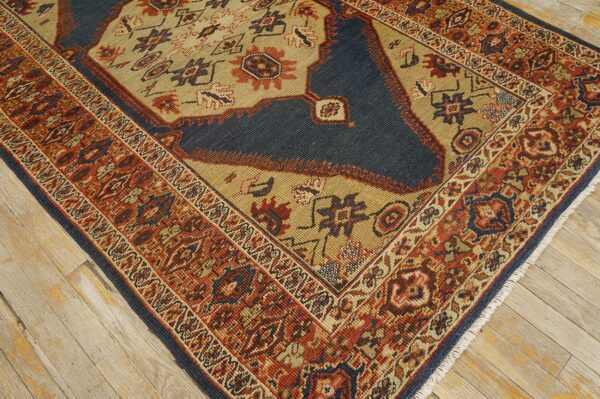 Close-up corner of a traditional rug featuring geometric patterns in rust, navy, and tan, by rugs on net. By rugs on net