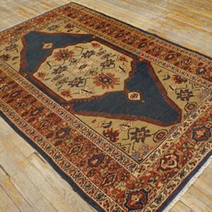 Close-up of a traditional Persian rug with blue and tan field on rustic wood floor by Rugs On Net