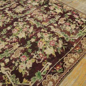 Close-up of a dark burgundy rug with a dense floral pattern featuring cream and pink roses, by Rugs On Net. by Rugs On Net