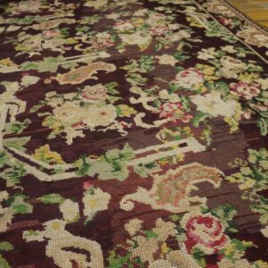 Close-up of a dark aubergine rug with ivory and pink floral motifs, by Rugs On Net