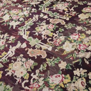 Close-up of a dark burgundy rug with a dense, colorful floral pattern, by Rugs On Net. by Rugs On Net