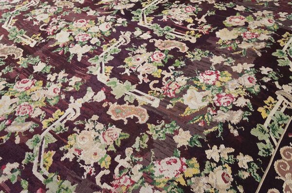Close-up of a dark burgundy rug with a dense, colorful floral pattern, by rugs on net. By rugs on net
