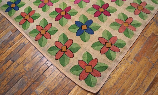 Close-up of a hooked rug with colorful floral patterns on a tan background, resting on wooden floors, by rugs on net