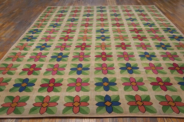Beige rug with repeating pattern of colorful stylized flowers in pink, blue, and coral, by rugs on net. By rugs on net
