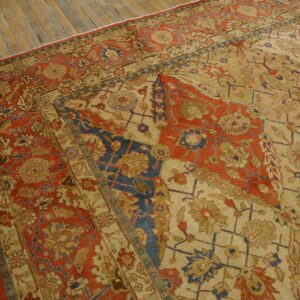 Close-up view of a richly patterned, antique Persian rug with faded reds and blues on a light field, by Rugs On Net. by Rugs On Net