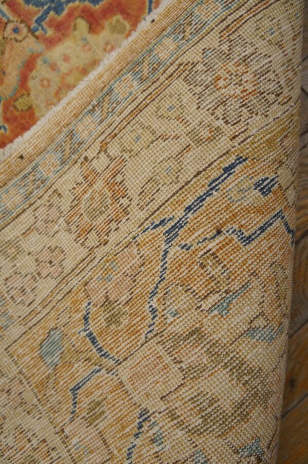 Close-up of the weave and faded pattern of the vintage rug by rugs on net. By rugs on net