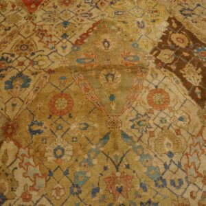 Close-up of an antique Persian rug with intricate gold, blue, and rust patterns by Rugs On Net. by Rugs On Net