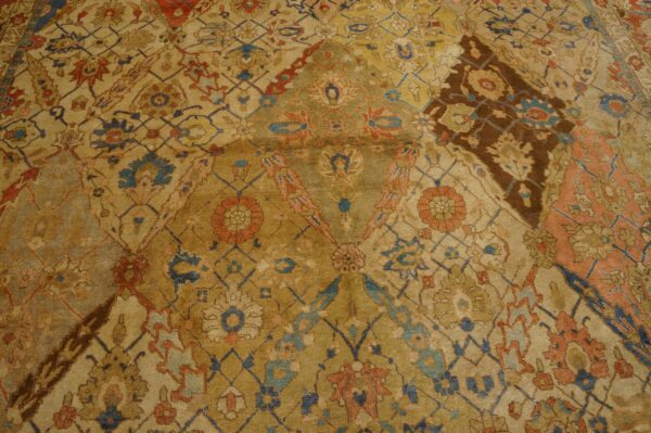 Close-up of an antique persian rug with intricate gold, blue, and rust patterns by rugs on net. By rugs on net