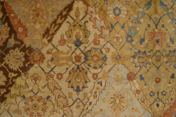 Close-up of a faded, traditional rug pattern featuring muted gold, terracotta, and blue accents by rugs on net. By rugs on net