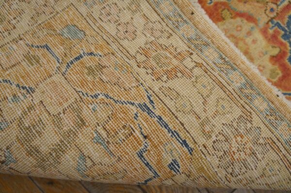 Close-up view of the backing and rolled edge of the vintage distressed rug by rugs on net. By rugs on net