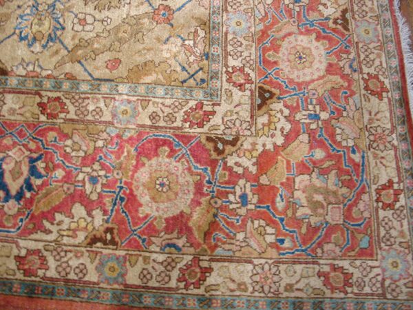 Close-up of a corner detail showing the intricate red, beige, and blue pattern of the oriental rug by rugs on net. By rugs on net