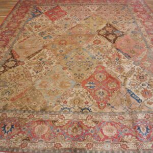 Close-up of a large, antique rug with a complex, multi-colored patchwork-style field featuring reds, blues, and golds, by Rugs On Net