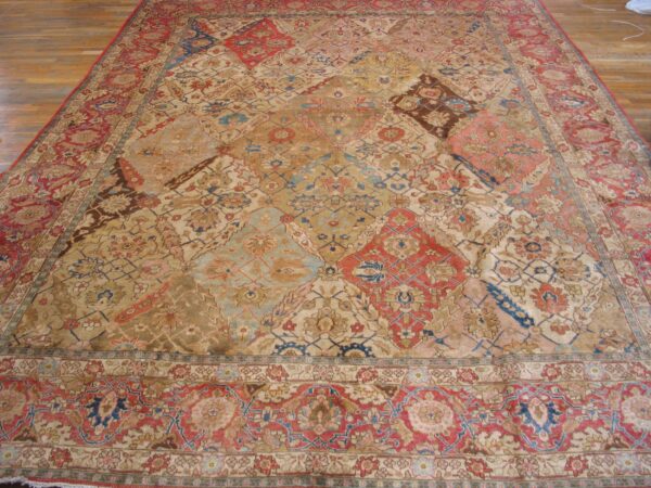 Close-up of a large, antique rug with a complex, multi-colored patchwork-style field featuring reds, blues, and golds, by rugs on net