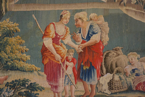 Pastoral scene featuring figures interacting, possibly a transaction, in a tapestry by rugs on net. By rugs on net