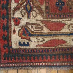 Close-up of an antique tribal rug border with geometric patterns in red, cream, and blue by Rugs On Net