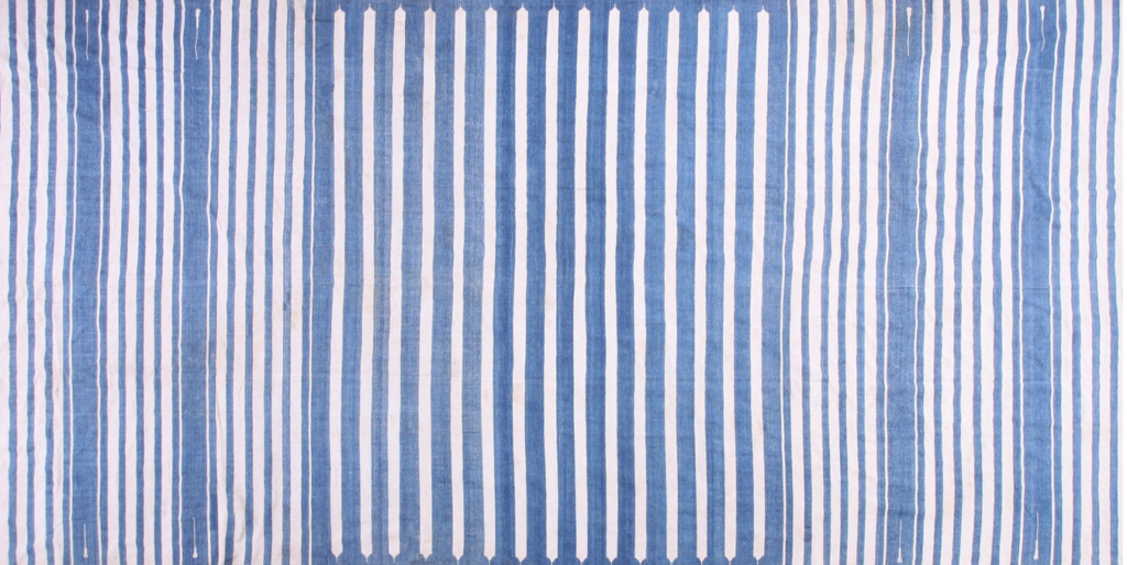 Blue and white vertical striped flatweave rug featuring decorative notched details on central stripes by rugs on net