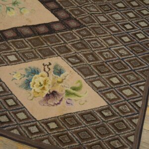 Close-up of a hooked rug featuring brown diamond patterns and a light field with yellow and purple floral accents, by Rugs On Net