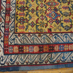 Close-up of the corner of a vibrant yellow field rug with geometric borders by Rugs On Net. by Rugs On Net