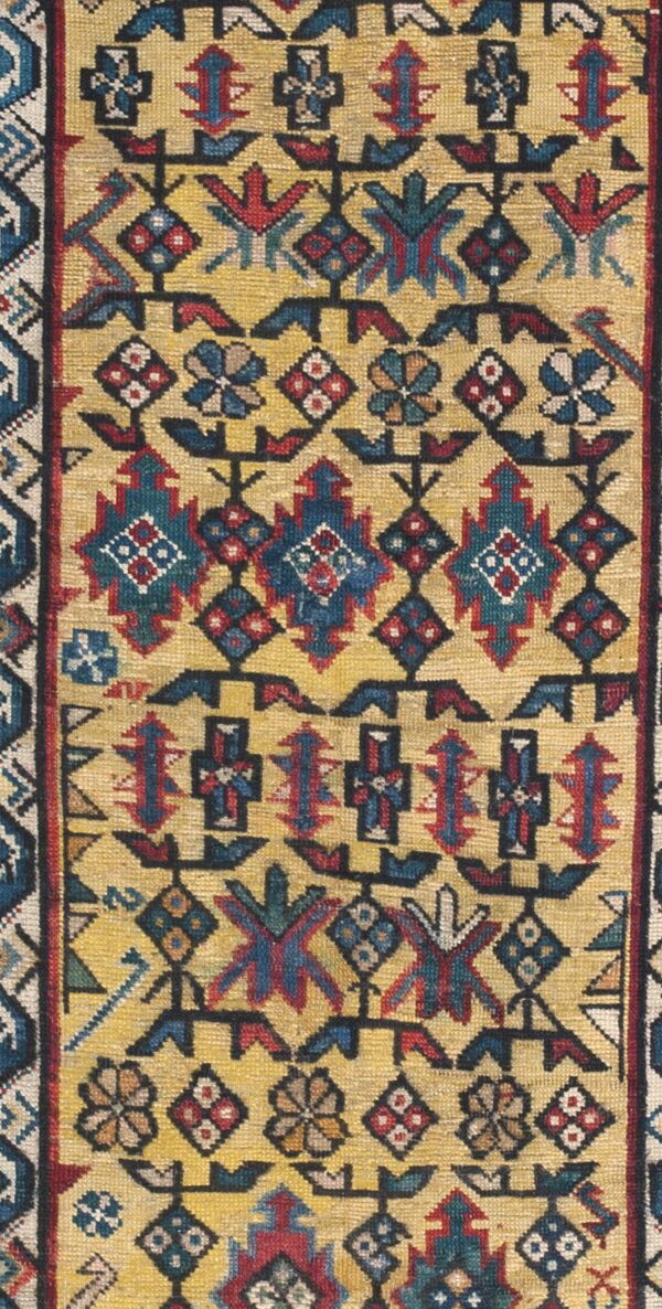 Close-up of an antique rug with geometric motifs on a gold field by rugs on net