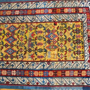 Close-up of a vibrant yellow field rug border with geometric patterns by Rugs On Net