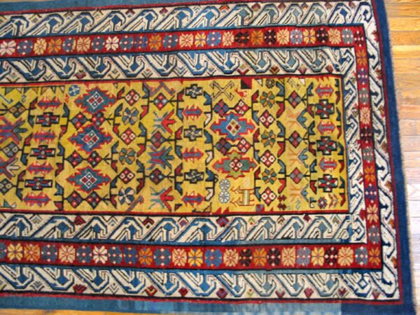 Close-up of a vibrant yellow field rug border with geometric patterns by rugs on net