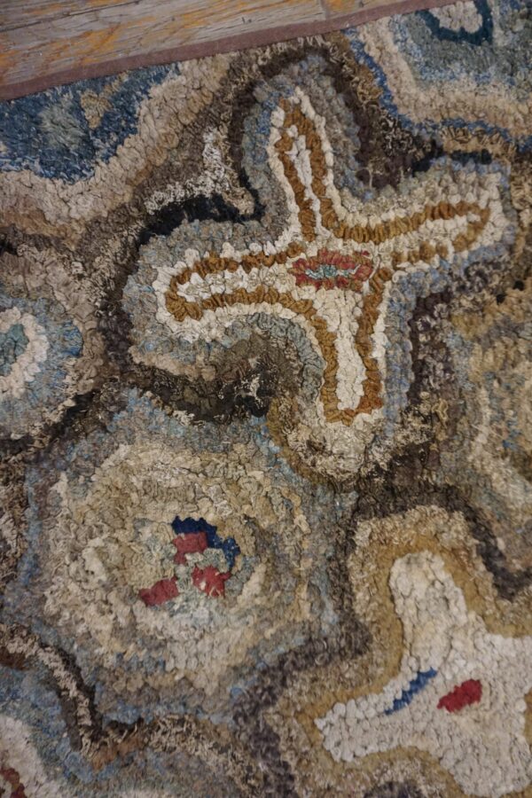 Close-up texture of a hooked rug featuring abstract brown, blue, and cream shapes, by rugs on net