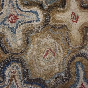 Close-up of a shaggy, textured rug with abstract brown, beige, and blue patterns, by Rugs On Net