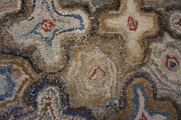Close-up of a shaggy, textured rug with abstract brown, beige, and blue patterns, by rugs on net