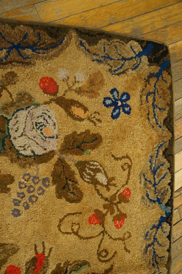 Close-up of a floral rug corner with tan ground and blue accents by rugs on net
